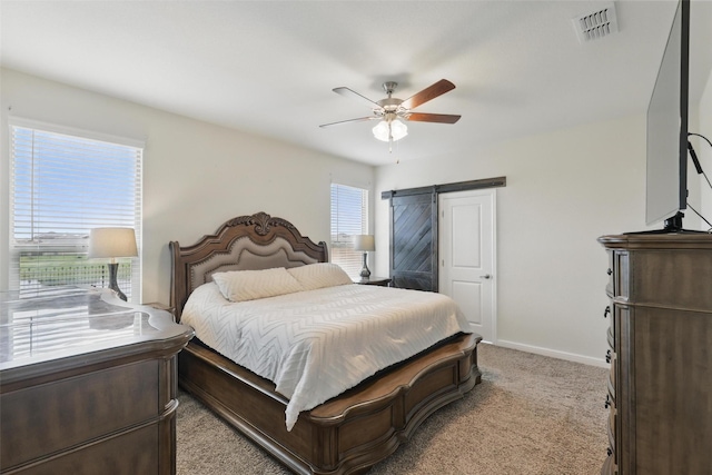 1206 Burlingame Dr, Cleburne, TX 76033 - carpeted bedroom with a barn door, baseboards, and ceiling fan