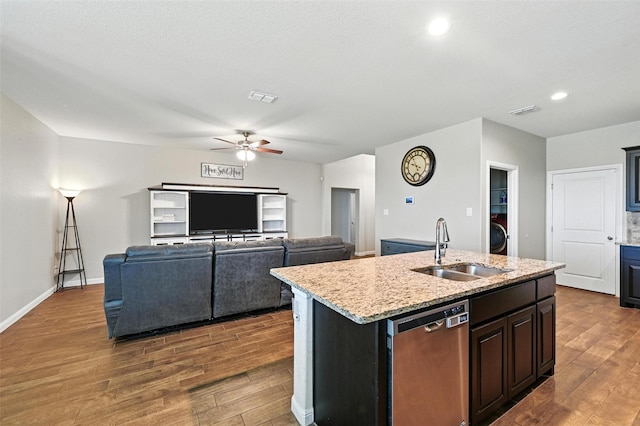 1206 Burlingame Dr, Cleburne, TX 76033 - kitchen with dishwasher, wood finished floors, ceiling fan, a center island with sink, and recessed lighting