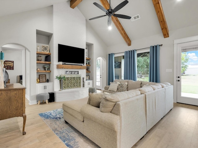 650 Winkler Way, Springtown, TX 76082 - living room featuring beamed ceiling, arched walkways, light wood finished floors, high vaulted ceiling, and ceiling fan