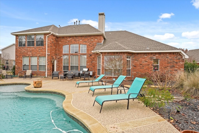 5610 Kensington Ct, Parker, TX 75002 - rear view of property featuring brick siding, a chimney, an outdoor pool, a patio area, and roof with shingles
