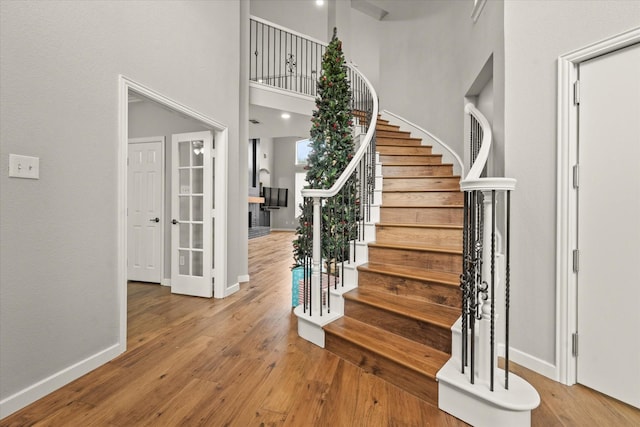 5610 Kensington Ct, Parker, TX 75002 - stairs with baseboards, wood finished floors, and a towering ceiling