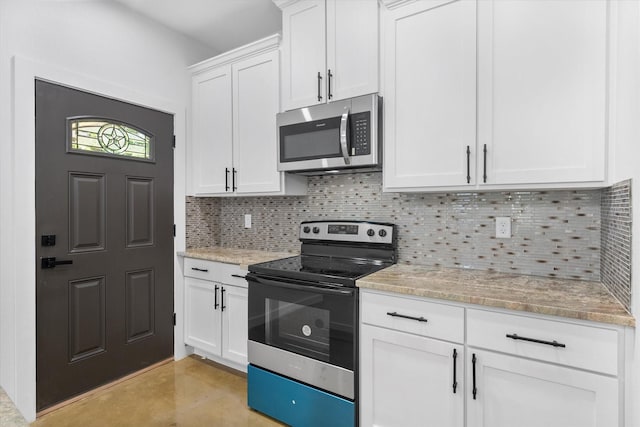 kitchen with black electric range, stainless steel microwave, decorative backsplash, white cabinets, and light stone countertops