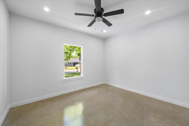 spare room featuring concrete floors, recessed lighting, baseboards, and a ceiling fan