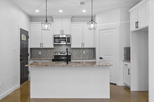 kitchen with appliances with stainless steel finishes, a sink, backsplash, a kitchen island with sink, and white cabinets