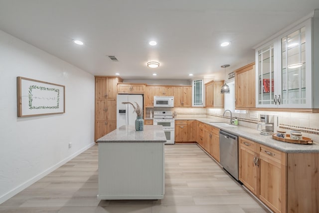 3048 Golfing Green Dr, Farmers Branch, TX 75234 - kitchen featuring white appliances, a sink, tasteful backsplash, a center island, and light wood-style floors