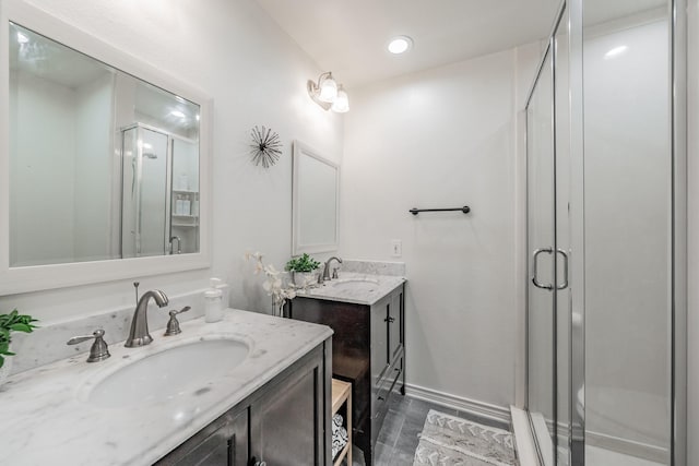 3048 Golfing Green Dr, Farmers Branch, TX 75234 - full bathroom featuring a stall shower, two vanities, wood finished floors, and baseboards