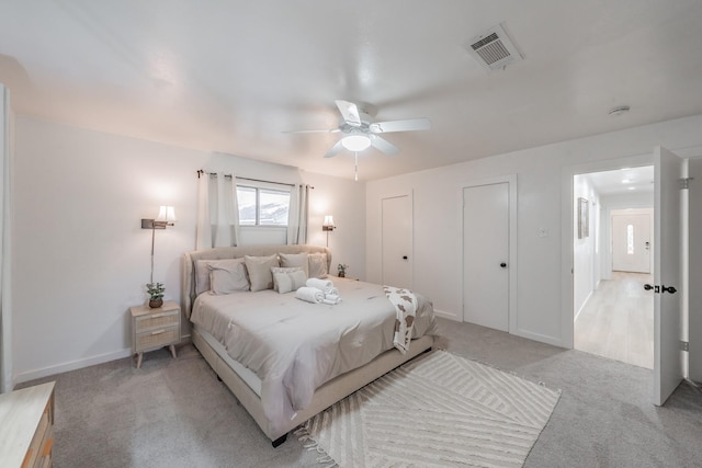 3048 Golfing Green Dr, Farmers Branch, TX 75234 - bedroom featuring light carpet, ceiling fan, and two closets