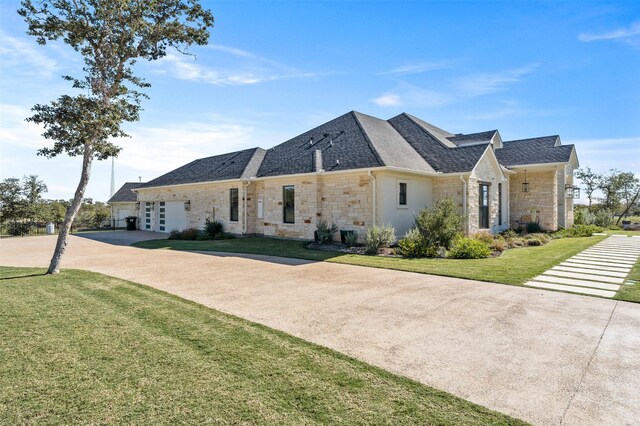 10072 Blanco Springs Rd, Temple, TX 76528 - view of front of house featuring stone siding, concrete driveway, a front yard, and an attached garage