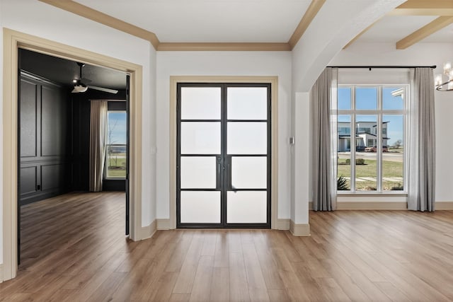 10072 Blanco Springs Rd, Temple, TX 76528 - doorway to outside featuring arched walkways, light wood-style floors, baseboards, plenty of natural light, and ornamental molding