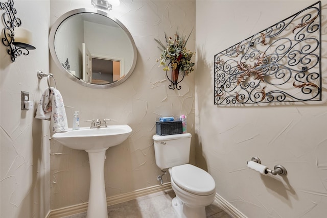 half bathroom with toilet and a sink
