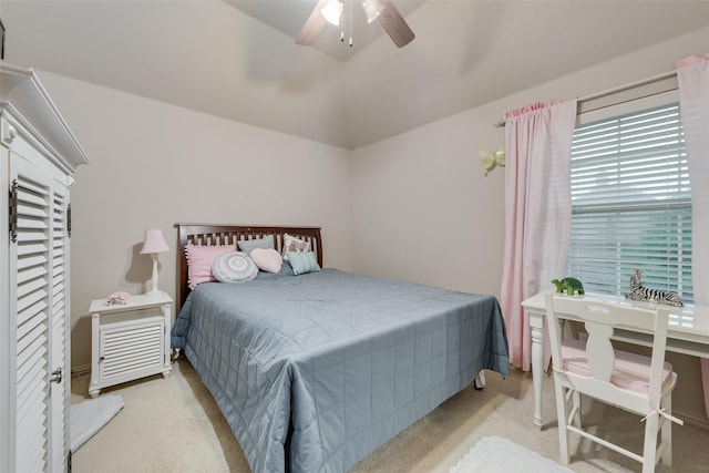 bedroom featuring carpet floors, vaulted ceiling, and a ceiling fan