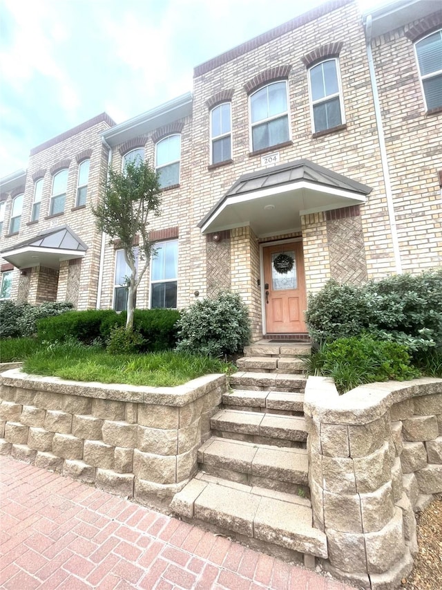 view of front of house with brick siding and entry steps