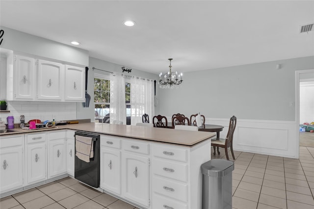 3205 Glasgow Ter, Arlington, TX 76015 - kitchen featuring a chandelier, a peninsula, black dishwasher, light tile patterned flooring, and a wainscoted wall