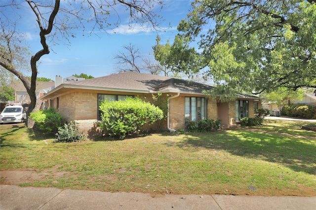 3205 Glasgow Ter, Arlington, TX 76015 - view of front of home featuring brick siding, a front lawn, a chimney, and a shingled roof