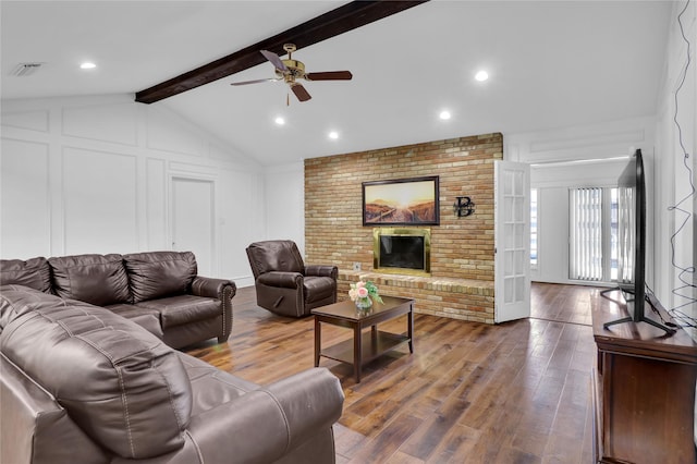 3205 Glasgow Ter, Arlington, TX 76015 - living room with ceiling fan, a decorative wall, wood finished floors, and a fireplace