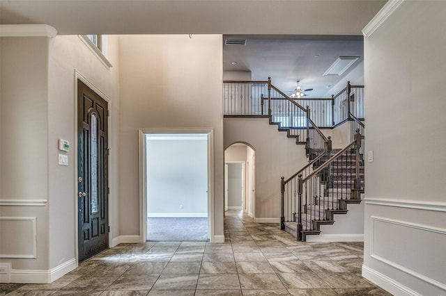 14015 Steadman Dr, Frisco, TX 75035 - foyer entrance featuring arched walkways, a high ceiling, a ceiling fan, stairway, and baseboards