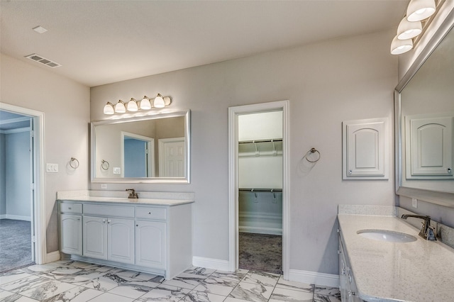 14015 Steadman Dr, Frisco, TX 75035 - bathroom with marble look tiles, baseboards, two vanities, and a walk in closet