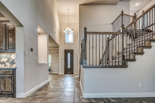 14015 Steadman Dr, Frisco, TX 75035 - foyer with a high ceiling, baseboards, a chandelier, and stairway