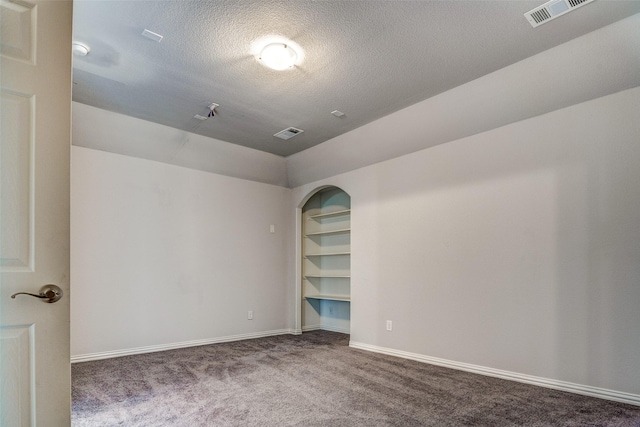 14015 Steadman Dr, Frisco, TX 75035 - carpeted empty room with a textured ceiling, vaulted ceiling, built in features, and baseboards
