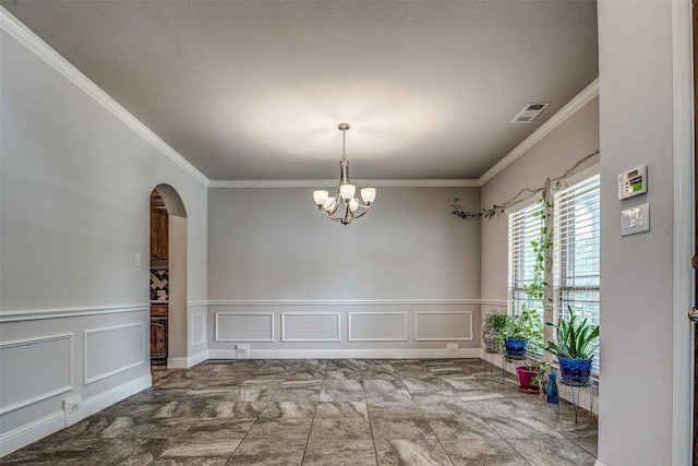 14015 Steadman Dr, Frisco, TX 75035 - unfurnished dining area featuring a decorative wall, crown molding, a chandelier, arched walkways, and wainscoting