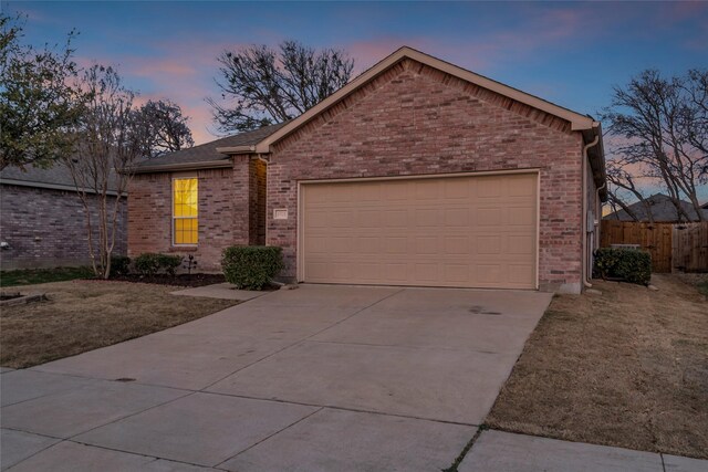 1321 Rivers Creek Ln, Little Elm, TX 75068 - ranch-style home featuring concrete driveway, brick siding, an attached garage, and fence