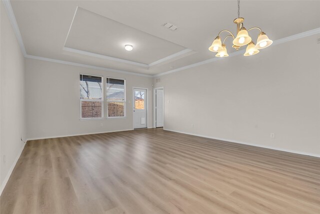 1321 Rivers Creek Ln, Little Elm, TX 75068 - spare room with a raised ceiling, a chandelier, light wood-style floors, baseboards, and ornamental molding