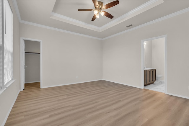1321 Rivers Creek Ln, Little Elm, TX 75068 - unfurnished bedroom with a raised ceiling, light wood finished floors, ornamental molding, a spacious closet, and baseboards