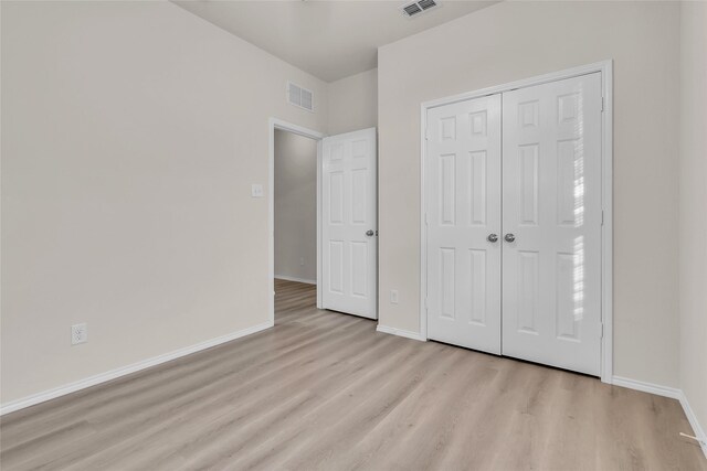 1321 Rivers Creek Ln, Little Elm, TX 75068 - unfurnished bedroom with light wood-style flooring, baseboards, and a closet