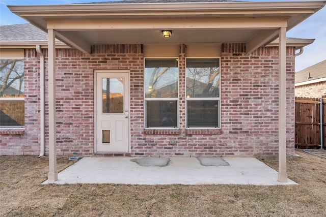 1321 Rivers Creek Ln, Little Elm, TX 75068 - entrance to property with fence, brick siding, a patio, and roof with shingles