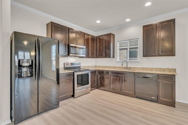 1321 Rivers Creek Ln, Little Elm, TX 75068 - kitchen featuring black appliances, light wood-type flooring, a sink, dark brown cabinets, and recessed lighting