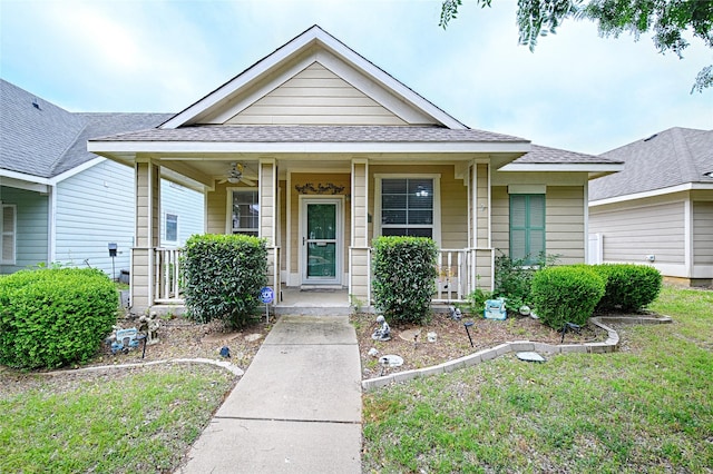 9912 Concord Dr, Providence Village, TX 76227 - view of front of property with covered porch, a ceiling fan, roof with shingles, and a front lawn