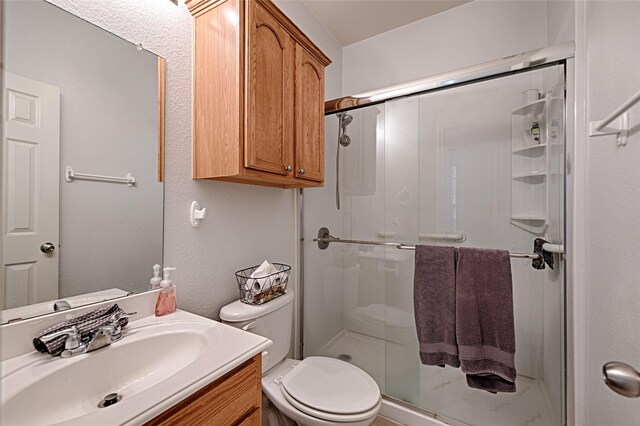 9912 Concord Dr, Providence Village, TX 76227 - full bathroom with a stall shower, vanity, and toilet
