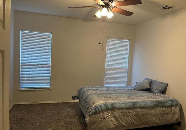 carpeted bedroom featuring baseboards and ceiling fan