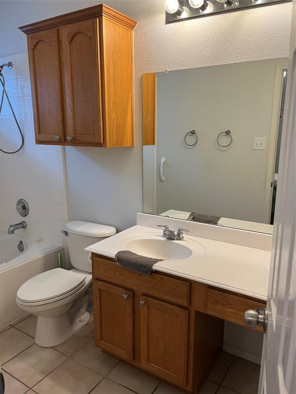 bathroom with vanity,  shower combination, toilet, and tile patterned floors