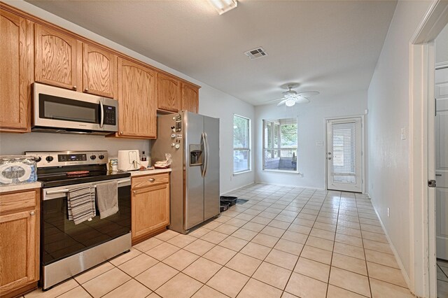 9912 Concord Dr, Providence Village, TX 76227 - kitchen featuring stainless steel appliances, light tile patterned flooring, a ceiling fan, and light countertops