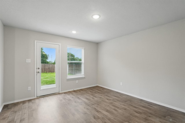 123 Rock Creek Ln, Terrell, TX 75160 - doorway with wood finished floors, baseboards, and recessed lighting