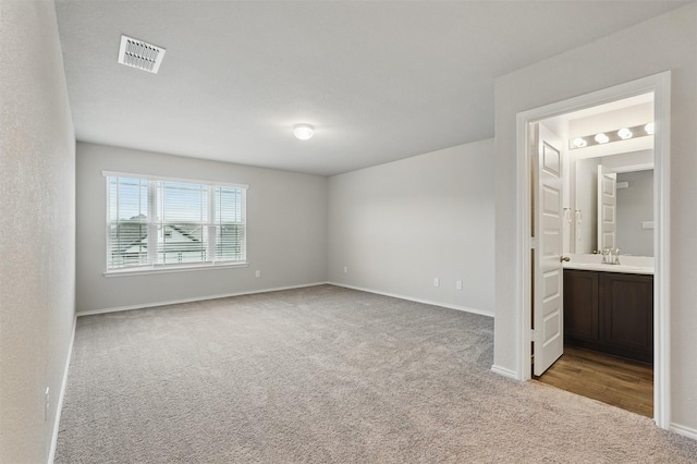 123 Rock Creek Ln, Terrell, TX 75160 - unfurnished bedroom with carpet flooring, baseboards, connected bathroom, and a sink