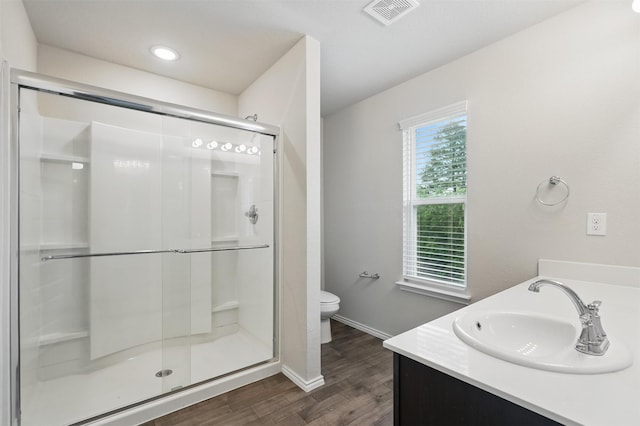 123 Rock Creek Ln, Terrell, TX 75160 - full bathroom with wood finished floors, a shower stall, toilet, vanity, and baseboards