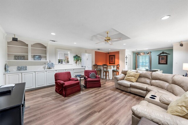 living room featuring ornamental molding, light wood-type flooring, recessed lighting, and a ceiling fan
