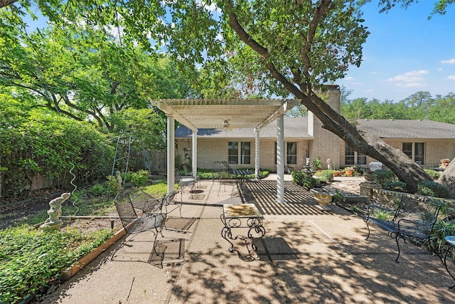 view of patio / terrace featuring a pergola and fence