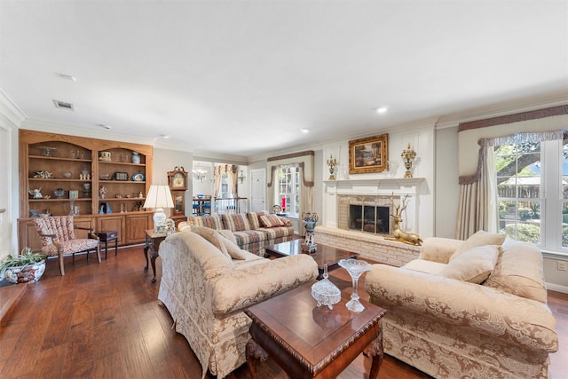 living area with dark wood-style floors, ornamental molding, and a brick fireplace