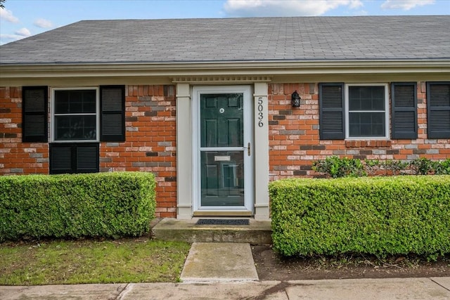 5036 Lake Shore Dr, Waco, TX 76710 - doorway to property featuring brick siding and a shingled roof
