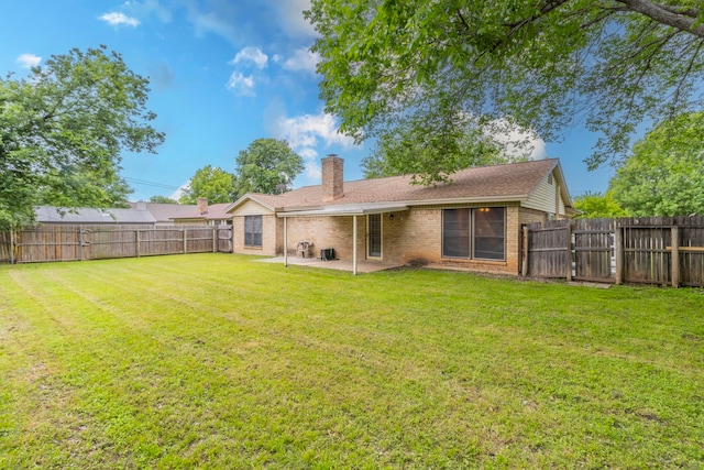 back of property featuring brick siding, a patio area, and a chimney