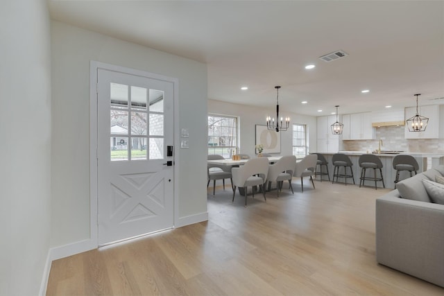 7319 Rutgers Dr, Dallas, TX 75214 - entryway with light wood-type flooring, a chandelier, recessed lighting, and baseboards