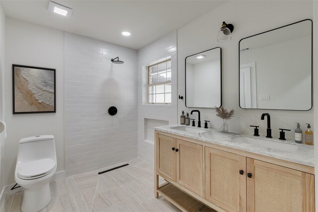 7319 Rutgers Dr, Dallas, TX 75214 - bathroom featuring walk in shower, toilet, and double vanity