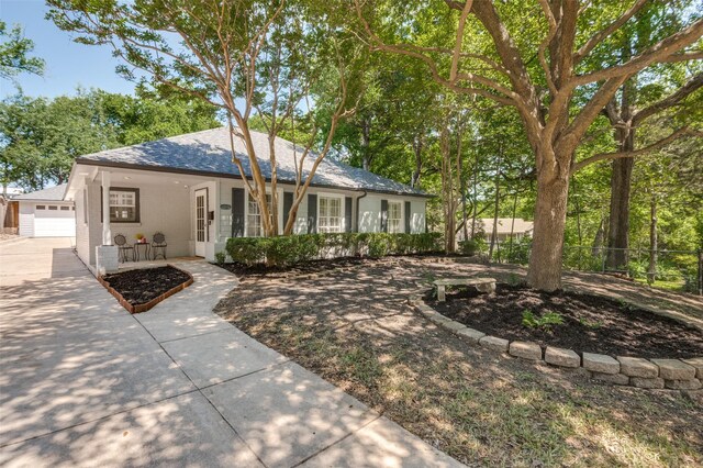 ranch-style house with fence, covered porch, and roof with shingles