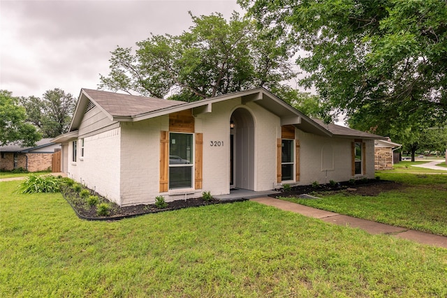 3201 Cardinal Ln, Irving, TX 75062 - mid-century modern home featuring brick siding, a front lawn, and a shingled roof
