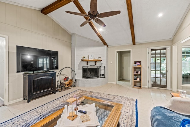 tiled living area featuring a fireplace, a ceiling fan, crown molding, baseboards, and wood walls