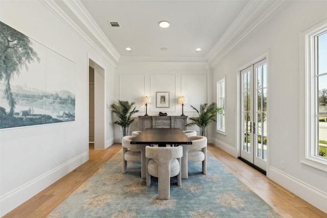 dining area with french doors, crown molding, light wood-style flooring, baseboards, and recessed lighting