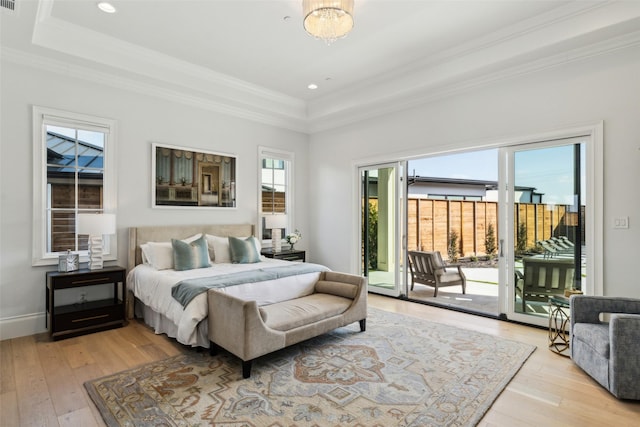 bedroom with a raised ceiling, ornamental molding, light wood-style floors, access to exterior, and recessed lighting